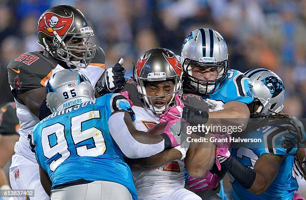 Charles Johnson and teammate Luke Kuechly of the Carolina Panthers tackle Jacquizz Rodgers of the Tampa Bay Buccaneers in the 1st quarter during the...