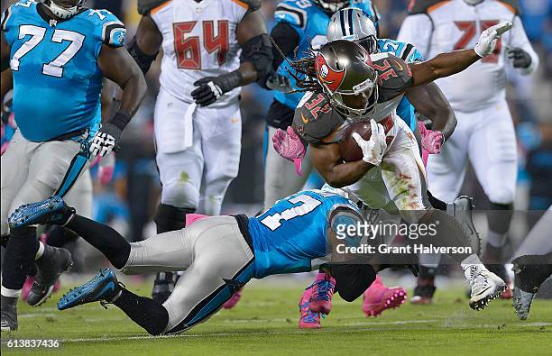 Jacquizz Rodgers of the Tampa Bay Buccaneers runs the ball against Robert McClain of the Carolina Panthers in the 1st quarter during the game at Bank...