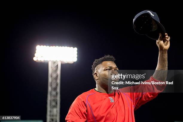 An emotional David Ortiz of the Boston Red Sox tips his cap to the fans after his final game in a loss to the Cleveland Indians in game three of the...