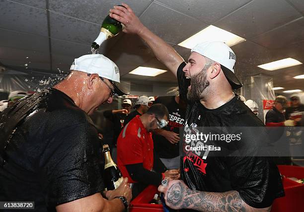 Mike Napoli of the Cleveland Indians celebrates with manager Terry Francona in the clubhouse after defeating the Boston Red Sox 4-3 in game three of...