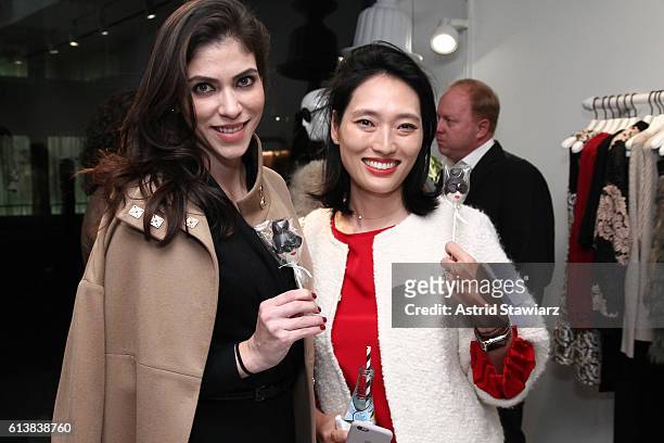 Alida Boer and Amanda Chu pose for a photo together as Sara Blakely and Alice + Olivia celebrate the launch of "The Belly Art Project" on October 10,...