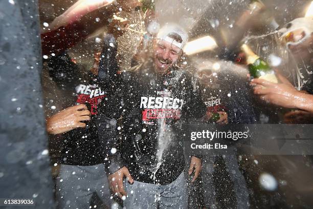 Josh Tomlin of the Cleveland Indians celebrates with teammates in the clubhouse after defeating the Boston Red Sox 4-3 in game three of the American...