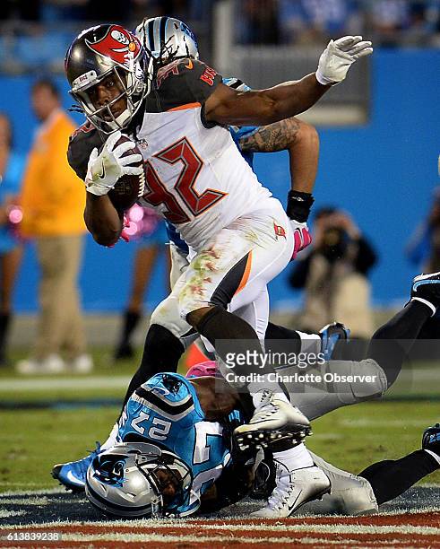 Carolina Panthers cornerback Robert McClain, bottom left, is unable to make the tackle on Tampa Bay Buccaneers running back Jacquizz Rodgers during...