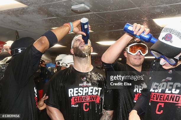 Mike Napoli of the Cleveland Indians celebrates with teammates in the clubhouse after defeating the Boston Red Sox 4-3 in game three of the American...