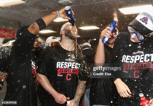 Mike Napoli of the Cleveland Indians celebrates with teammates in the clubhouse after defeating the Boston Red Sox 4-3 in game three of the American...