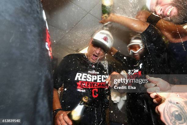 Manager Terry Francona of the Cleveland Indians celebrates with players in the clubhouse after defeating the Boston Red Sox 4-3 in game three of the...