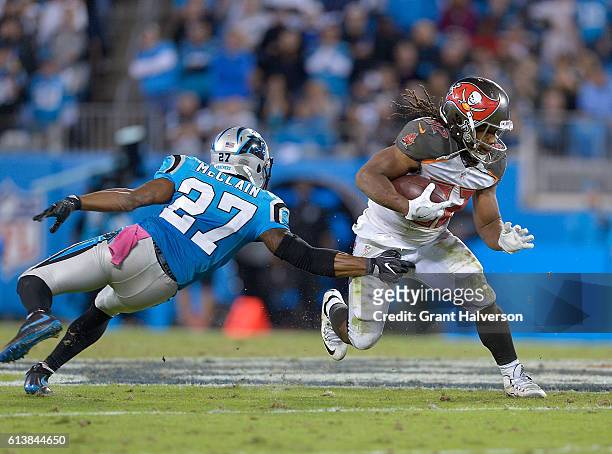 Jacquizz Rodgers of the Tampa Bay Buccaneers breaks away from Robert McClain of the Carolina Panthers during the game at Bank of America Stadium on...