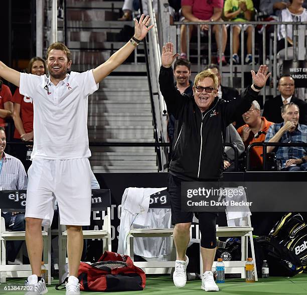 Former tennis player Mardy Fish and recording artist Sir Elton John cheer during the World TeamTennis Smash Hits charity tennis event benefiting the...