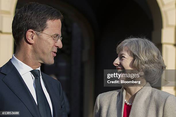 Theresa May, U.K. Prime minister, right, reacts as she arrives for a meeting with Mark Rutte, Dutch prime minister, at the Ministry of General...