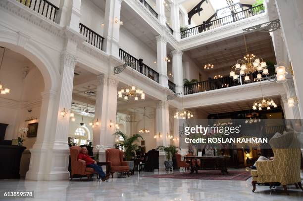 General view of the lobby of the Raffles Hotel in Singapore on October 11, 2016. - Singapore's Raffles Hotel announced on October 11 that it will...