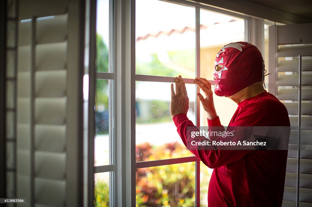 Mexican luchador looking thru the windows