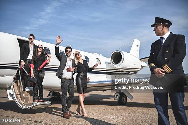 pilot and passangers of private jet airplane - chauffeurs stock pictures, royalty-free photos & images