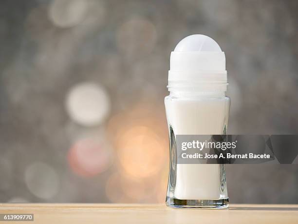 roll-on deodorant, close up, in glass jar, illuminated by sunlight - roll on fotografías e imágenes de stock