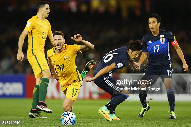 Apostolos Giannou of the Socceroos is tripped by Hotaru Yamaguchi of Japan during the 2018 FIFA World Cup Qualifier match between the Australian...