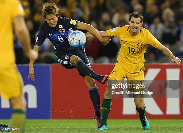 Genki Haraguchi of Japan and Ryan McGowan of the Socceroos compete for the ball during the 2018 FIFA World Cup Qualifier match between the Australian...