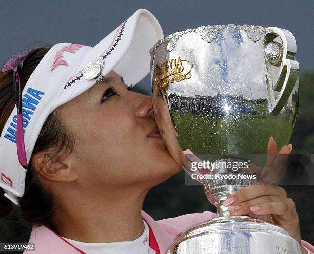 Japan - Chie Arimura kisses the victor's trophy after winning her first Japanese major with a 13-under-par 275 at the Japan LPGA Championship at...