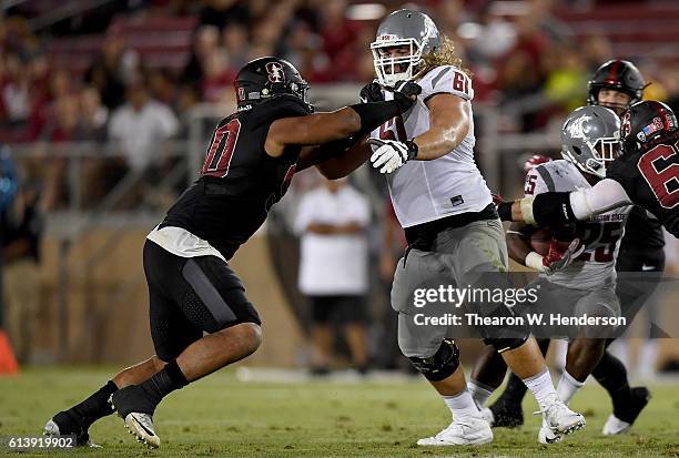 Solomon Thomas of the Stanford Cardinal rushes up against Cole Madison of the Washington State Cougars during their NCAA football game at Stanford...