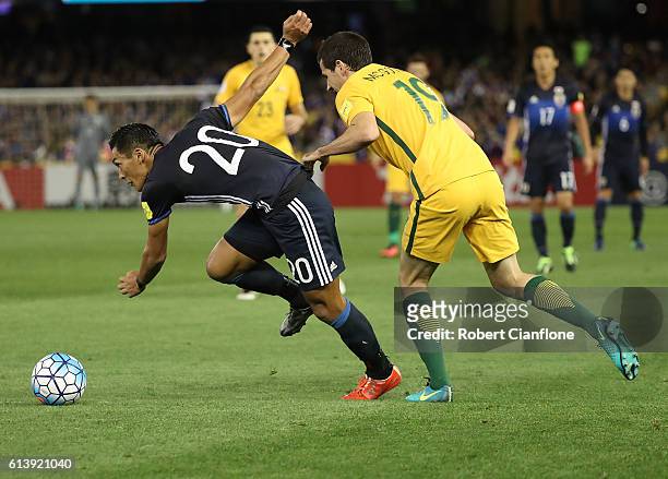 Tomoaki Makino of Japan is challenged by Ryan McGowan of Australia during the 2018 FIFA World Cup Qualifier match between the Australian Socceroos...