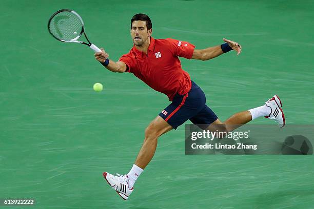 Novak Djokovic of Serbia returns a shot against Fabio Fognini of Italy during the Men's singles first round match on day three of Shanghai Rolex...