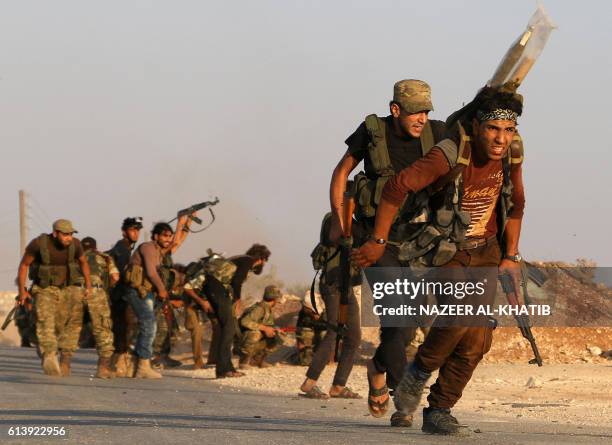 Fighters from the Free Syrian Army take part in a battle against the Islamic State group jihadists in the northern Syrian village of Yahmoul in the...