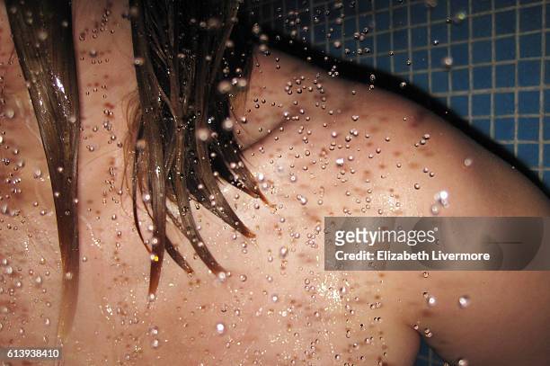 woman in a shower - women taking showers stock pictures, royalty-free photos & images
