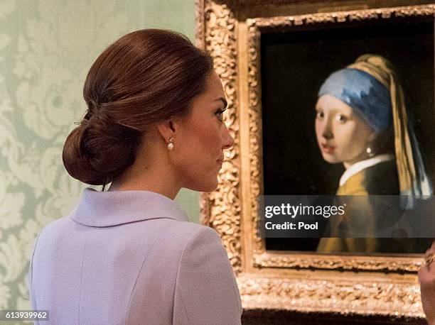 Catherine, Duchess of Cambridge views the 'Girl with a Pearl Earring' by Johannes Vermeer as she visits the Mauritshuis Gallery during a solo visit...