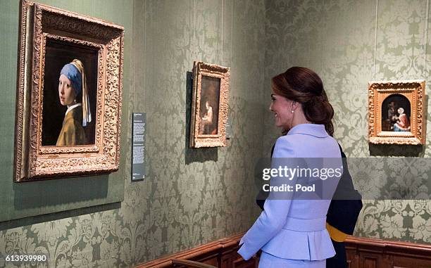 Catherine, Duchess of Cambridge views the 'Girl with a Pearl Earring' by Johannes Vermeer as she visits the Mauritshuis Gallery during a solo visit...