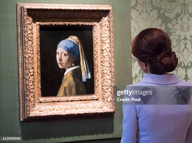 Catherine, Duchess of Cambridge views the 'Girl with a Pearl Earring' by Johannes Vermeer as she visits the Mauritshuis Gallery during a solo visit...