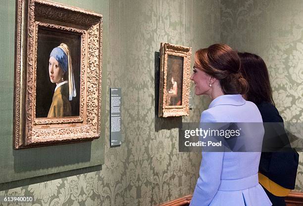 Catherine, Duchess of Cambridge views the 'Girl with a Pearl Earring' by Johannes Vermeer as she visits the Mauritshuis Gallery during a solo visit...