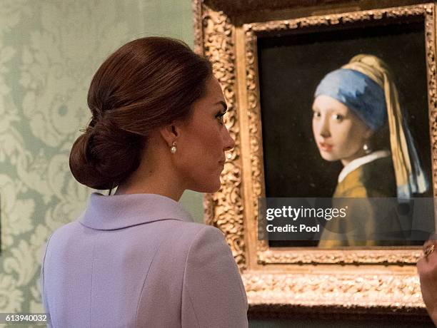 Catherine, Duchess of Cambridge views the 'Girl with a Pearl Earring' by Johannes Vermeer as she visits the Mauritshuis Gallery during a solo visit...