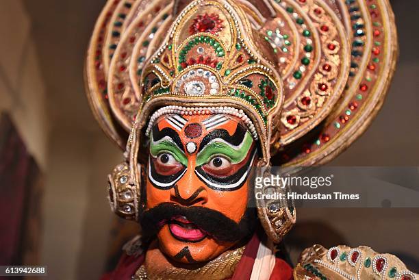 Swapan Majumdar, an artist of Shri Ram Bhartiya Kala Kendra, dress up and makeup as Ravana, the part of performing Ramleela, during the celebration...