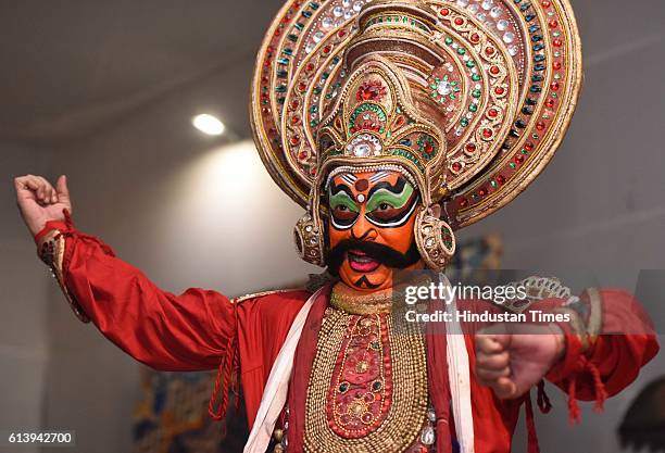 Swapan Majumdar, an artist of Shri Ram Bhartiya Kala Kendra, dress up and makeup as Ravana, the part of performing Ramleela, during the celebration...