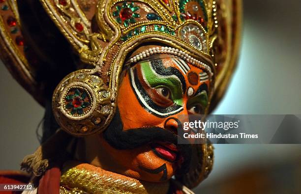 Swapan Majumdar, an artist of Shri Ram Bhartiya Kala Kendra, dress up and makeup as Ravana, the part of performing Ramleela, during the celebration...