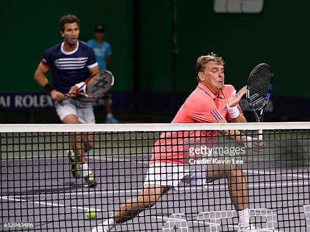 Marcin Matkowski of Poland and Jean-Julien Rojer of Netherlands in action against Martin Klizan of Slovakia and Joao Sousa of Portugal in a match in...