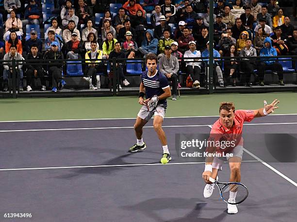 Marcin Matkowski of Poland and Jean-Julien Rojer of Netherlands in action against Martin Klizan of Slovakia and Joao Sousa of Portugal in a match in...