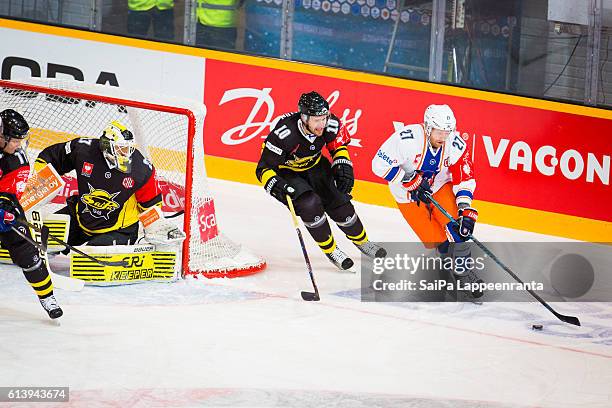 Jussi Markkanen and Curtis Hamilton of Lappeenranta challenges Martin Roymark of Tampere during the Champions Hockey League Round of 32 match between...