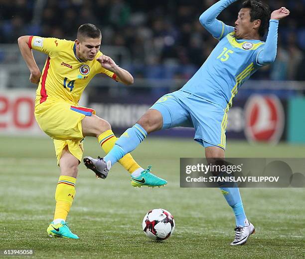 Romania's Razvan Marin vies with Kazakhstan's Maksat Bayzhanov during the WC 2018 football qualification match between Kazakhstan and Romania in...