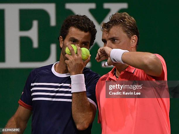 Marcin Matkowski of Poland and Jean-Julien Rojer of Netherland in action against Martin Klizan of Slovakia and Joao Sousa of Portugal in a match in...