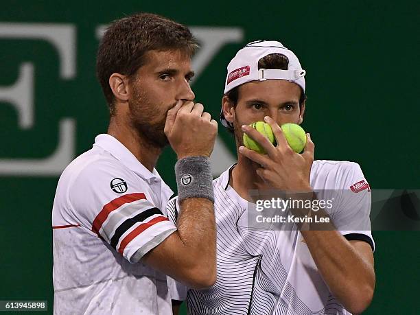 Martin Klizan of Slovakia and Joao Sousa of Portugal in action against Marcin Matkowski of Poland and Jean-Julien Rojer of Netherland during a match...