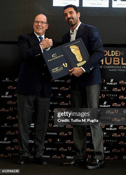 Prince Albert II of Monaco gives the Golden Foot 2016 Award trophy to Gianluigi Buffon during the Golden Foot Ceremony Award on October 11, 2016 in...