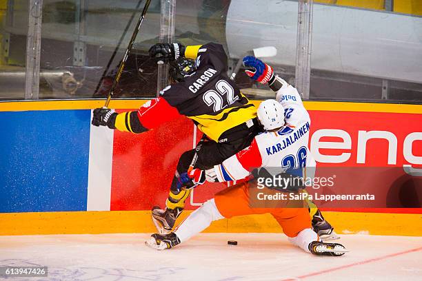 Brett Carson of Lappeenranta challenges Jere Karjalainen of Tampere during the Champions Hockey League Round of 32 match between SaiPa Lappeenranta...