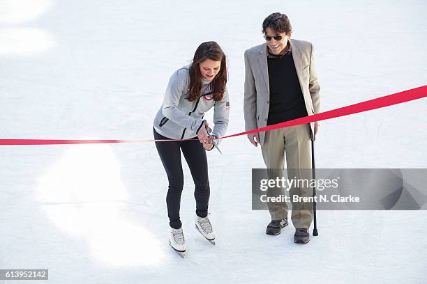 Olympic figure skating champion Sasha Cohen and choreographer Edward Villella cut the ribbon during The Rink at Rockefeller Center's 80th Anniversary...