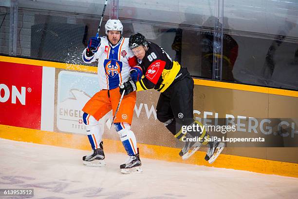 Ville Vainikainen of Lappeenranta hits Tapio Sammalkangas of Tampere during the Champions Hockey League Round of 32 match between SaiPa Lappeenranta...