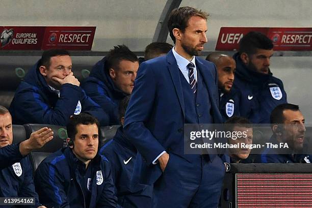 Wayne Rooney of England looks on from the bench as Interim England Manager Gareth Southgate watches the action from the touchline during the FIFA...