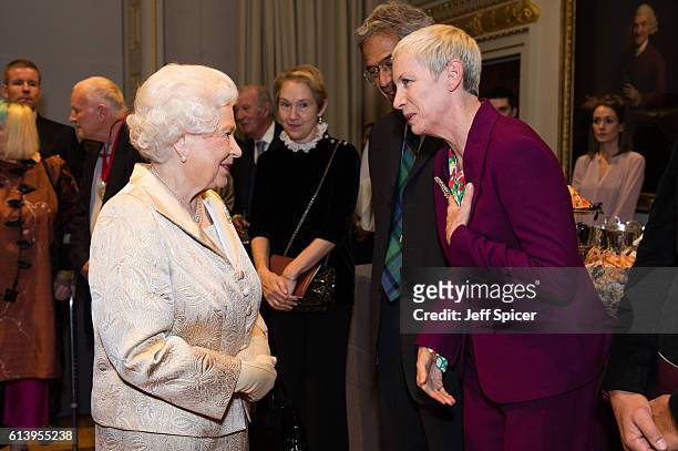 Queen Elizabeth II greets Annie Lennox as they attend a reception and awards ceremony at Royal Academy of Arts on October 11, 2016 in London, England.