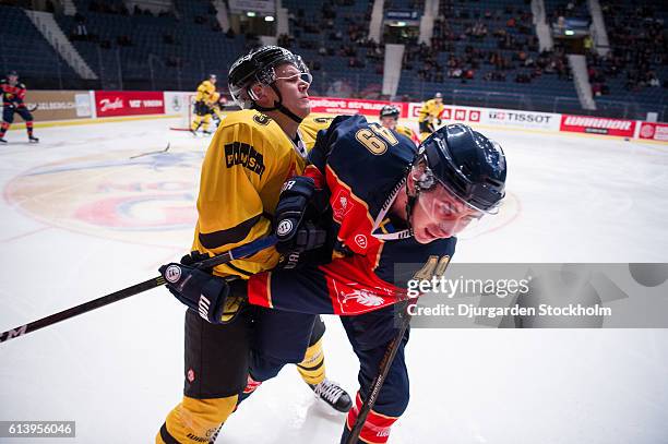 Defenceman Santeri Lukka of Kalpa tackles Defenceman David Bernhardt of Djurgarden during the Champions Hockey League Round of 32 match between...