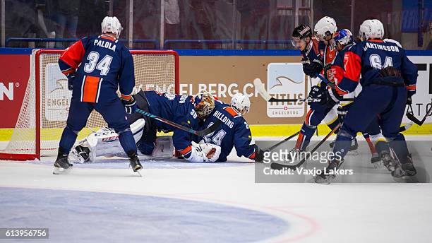 Joakim Hillding of Vaxjo Lakers and Joacim Andersson Goaltender of Vaxjo Lakers covers up the puck during the Champions Hockey League Round of 32...