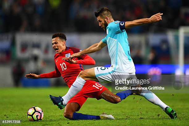 Dele Alli of England battles for the ball with Bostjan Cesar of Slovenia during the FIFA 2018 World Cup Qualifier Group F match between Slovenia and...