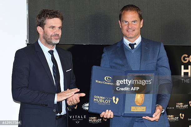 Former Dutch football player and Inter Milan manager Frank de Boer poses after receiving a Golden Foot award from French journalist Herve Matou on...