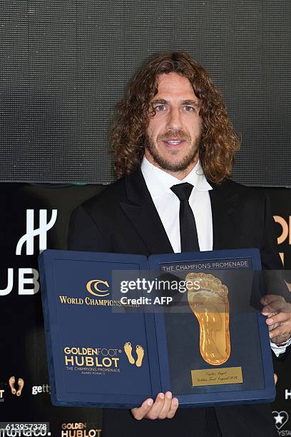 Former Spanish football player Carles Puyol poses after receiving a Golden Foot award from French journalist Herve Matou on October 11, 2016 in...